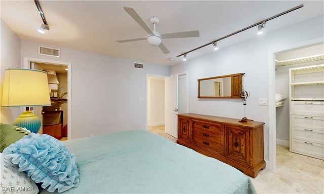 bedroom with ceiling fan and track lighting