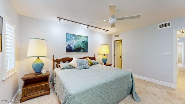 bedroom with track lighting and ceiling fan