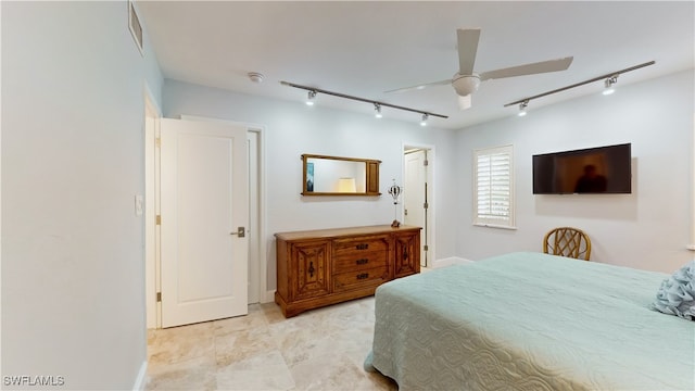 bedroom with ceiling fan and track lighting