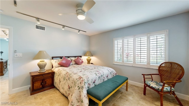 bedroom with ceiling fan and track lighting