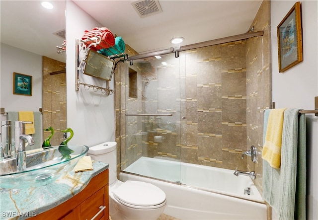 full bathroom with vanity, toilet, and bath / shower combo with glass door