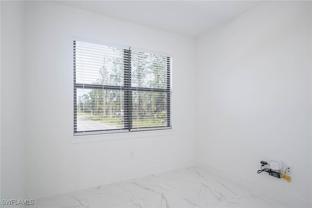 2844 37th Ave NE, Naples, FL 34120 - empty room featuring marble look tile flooring