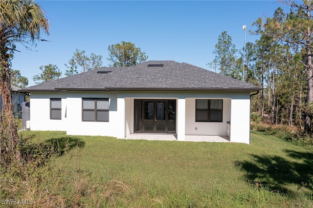 back of house with a patio and a lawn