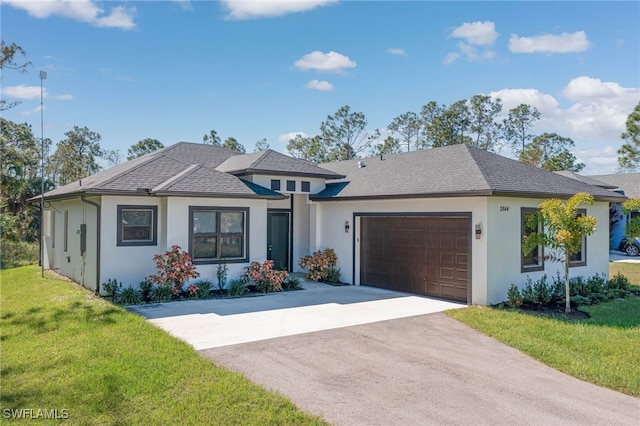 view of front of home featuring a garage and a front yard