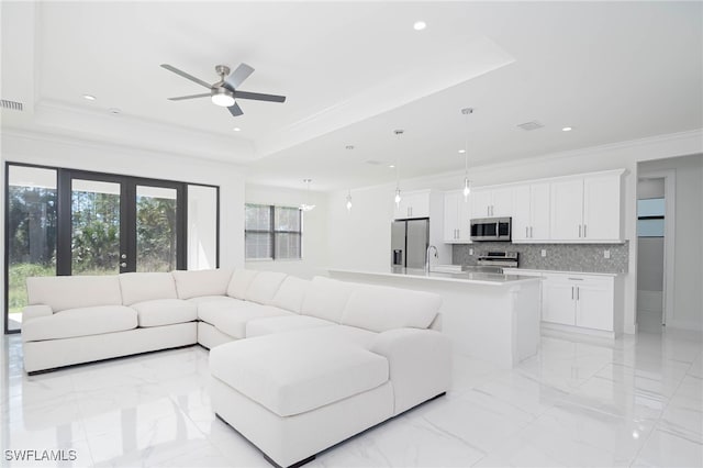2844 37th Ave NE, Naples, FL 34120 - living room with a tray ceiling, light marble finish flooring, recessed lighting, ceiling fan, and crown molding