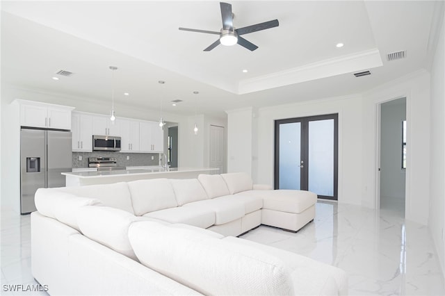 2844 37th Ave NE, Naples, FL 34120 - living room featuring a ceiling fan, light marble finish floors, recessed lighting, a tray ceiling, and crown molding