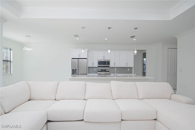 living room with crown molding and sink