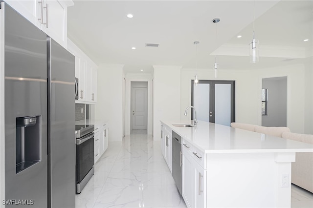 2844 37th Ave NE, Naples, FL 34120 - kitchen with stainless steel appliances, recessed lighting, light marble finish floors, white cabinetry, and ornamental molding