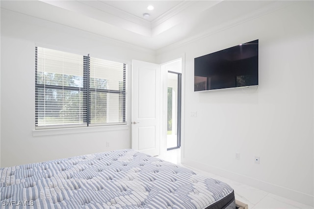 unfurnished bedroom featuring ornamental molding and a tray ceiling