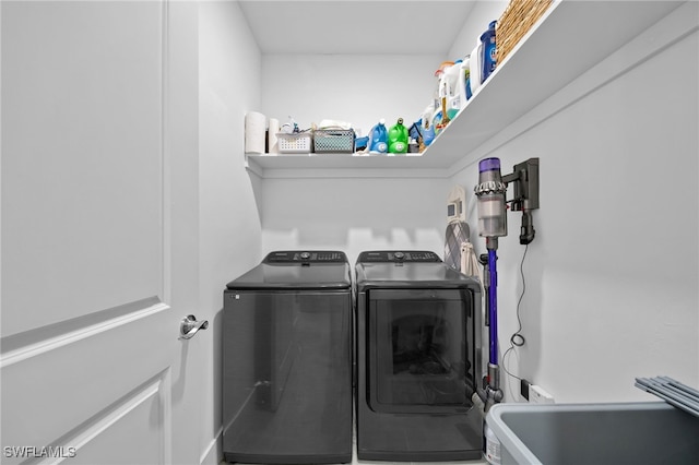 laundry room featuring independent washer and dryer and sink