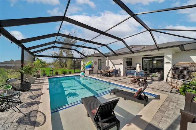 view of swimming pool with ceiling fan, a patio area, and a lanai