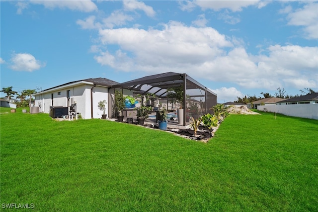 view of yard with a lanai and central AC unit