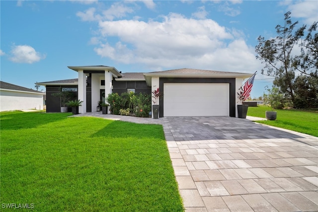 prairie-style house featuring a garage and a front lawn