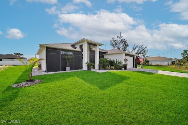 view of front of property with a front yard and a garage