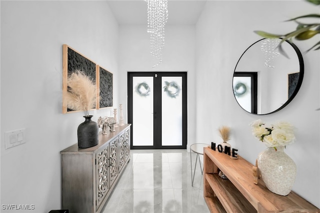 entryway featuring french doors and an inviting chandelier