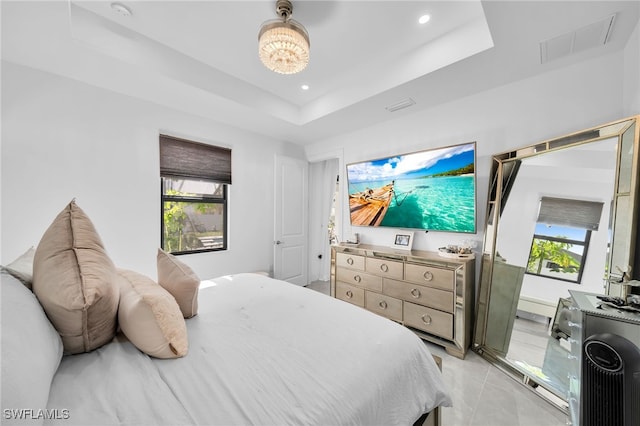 tiled bedroom featuring a raised ceiling