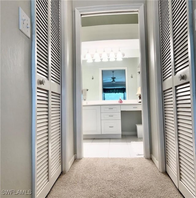 hall featuring light tile patterned floors