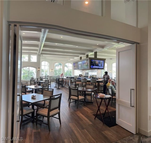 dining room featuring beam ceiling and hardwood / wood-style floors