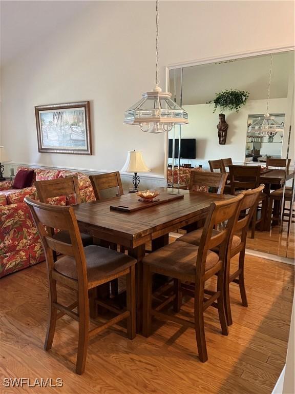 dining area featuring a notable chandelier and wood-type flooring