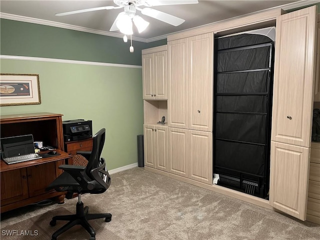 carpeted home office featuring ornamental molding and ceiling fan