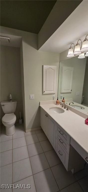 bathroom featuring vanity, tile patterned floors, and toilet