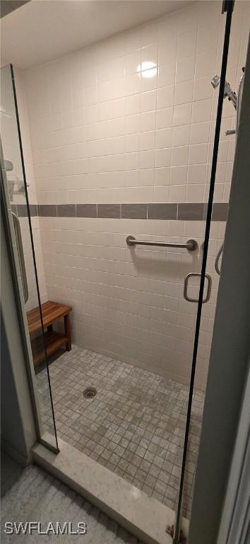 bathroom with tile patterned flooring and walk in shower