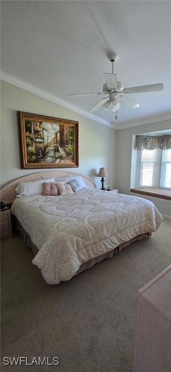 carpeted bedroom featuring ceiling fan and ornamental molding