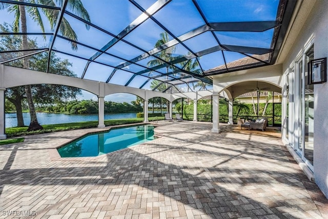 view of swimming pool with a patio, a water view, an outdoor hangout area, and a lanai