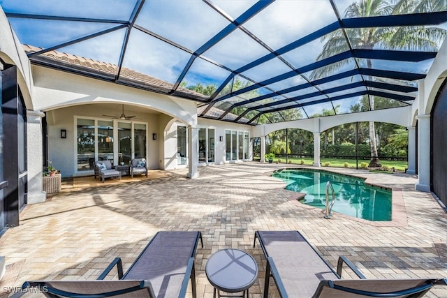 view of swimming pool featuring a lanai, ceiling fan, and a patio area