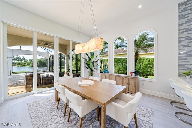 sunroom / solarium featuring plenty of natural light and a water view