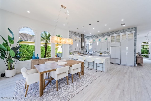 dining space with light hardwood / wood-style flooring