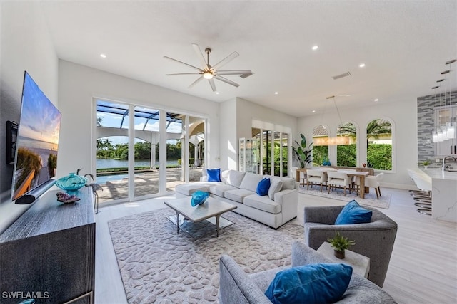 interior space with ceiling fan and light hardwood / wood-style floors