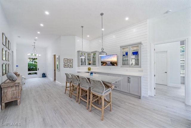 kitchen featuring hanging light fixtures, light hardwood / wood-style floors, and a wealth of natural light