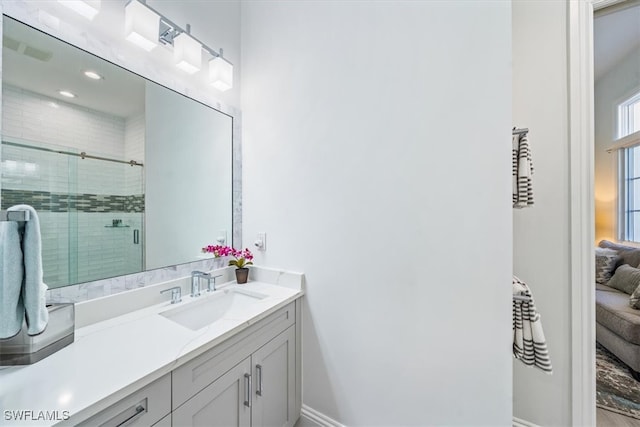 bathroom with vanity and a shower with door