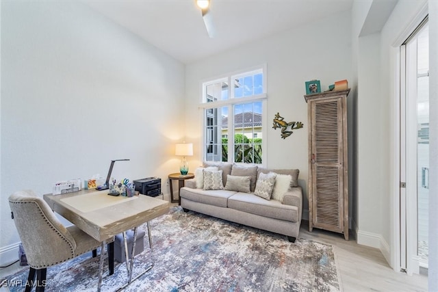 living room with light hardwood / wood-style flooring and a healthy amount of sunlight