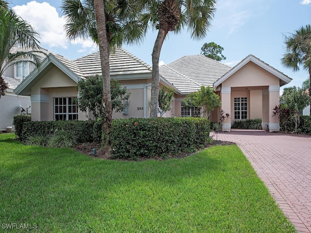 ranch-style home featuring a front yard