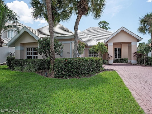 584 Eagle Creek Dr, Naples, FL 34113 - single story home featuring a front yard, stucco siding, and a tile roof
