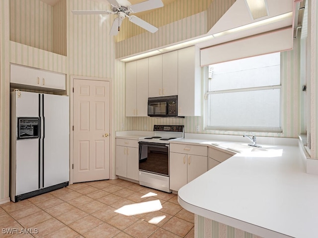 kitchen featuring white cabinetry, ceiling fan, sink, white appliances, and light tile patterned floors