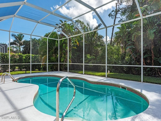 view of swimming pool featuring a patio and glass enclosure