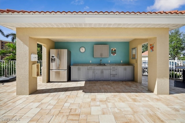 view of patio / terrace featuring area for grilling and sink