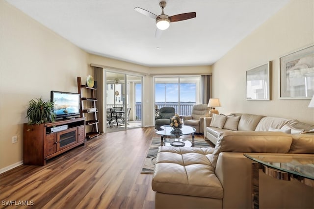 living room with dark hardwood / wood-style floors and ceiling fan