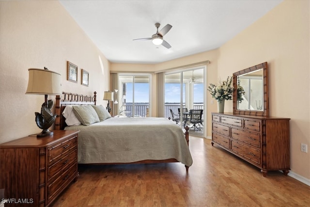 bedroom with access to exterior, hardwood / wood-style flooring, and ceiling fan