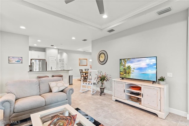 tiled living room featuring crown molding and ceiling fan