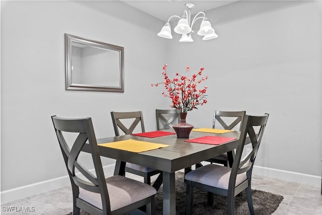 dining area featuring a chandelier and light tile patterned floors