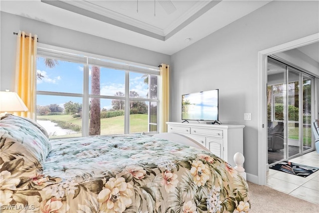 carpeted bedroom with a raised ceiling, crown molding, and access to exterior