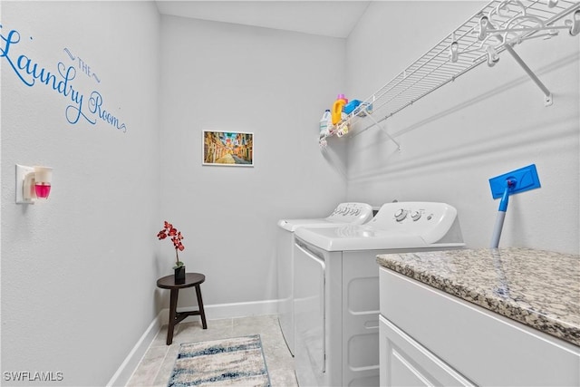 clothes washing area with light tile patterned floors and washing machine and clothes dryer