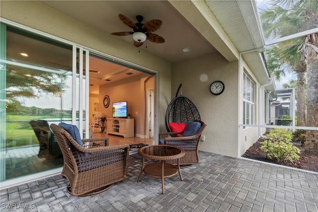 view of patio with ceiling fan and a lanai