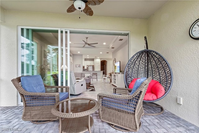 view of patio featuring ceiling fan