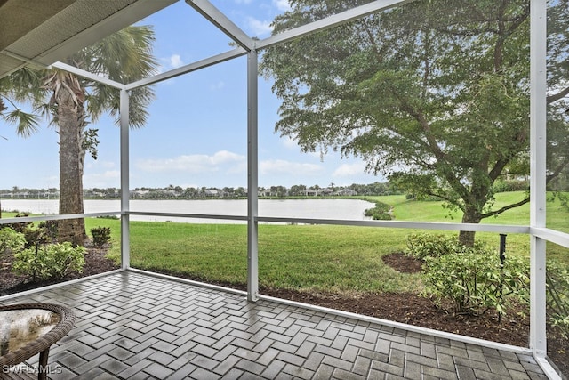 unfurnished sunroom with a water view