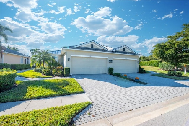 ranch-style house featuring a garage and a front lawn